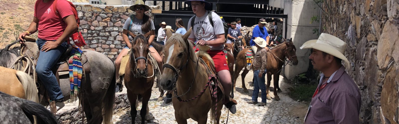 Family traveling on horseback in rural Mexico